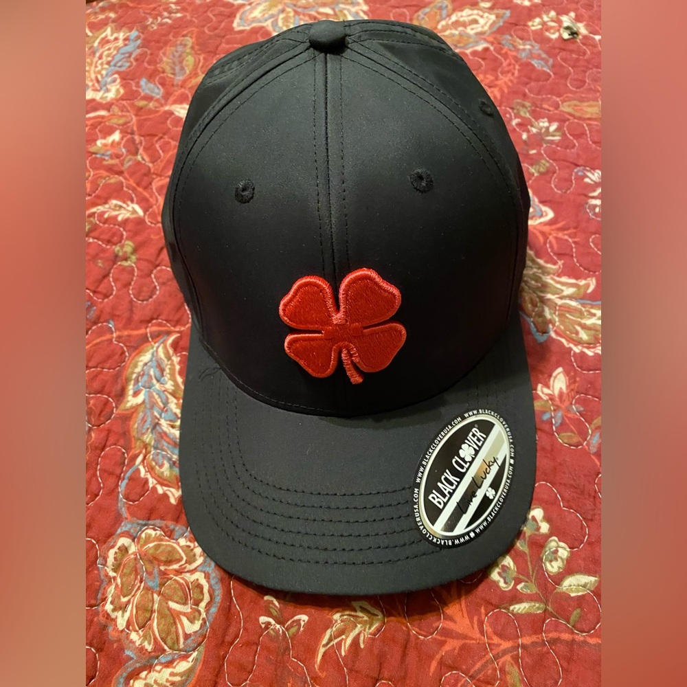 Stylish and comfortable, this cap features a bold red clover. Brand new.